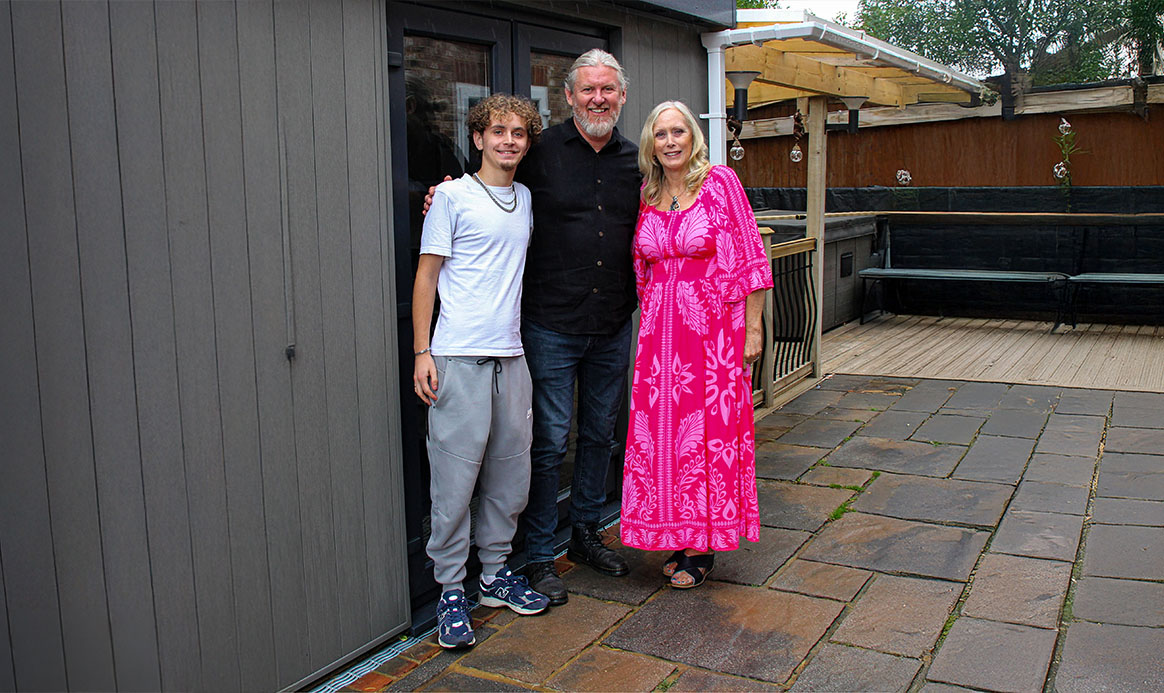 Three people together outside at the Darkroom Door handover