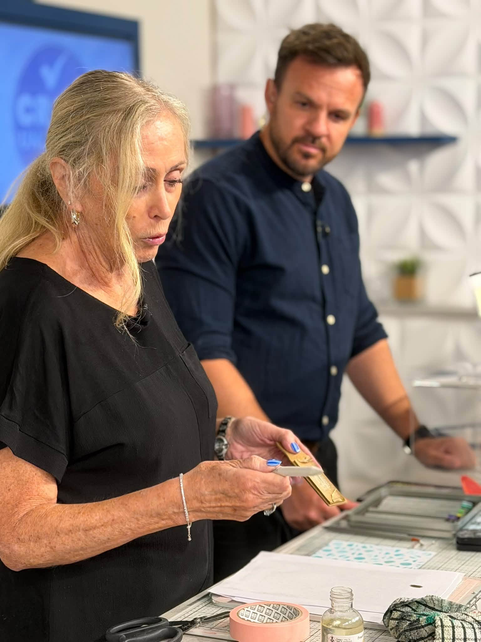A close-up of Karen preparing a stamp during a demonstration