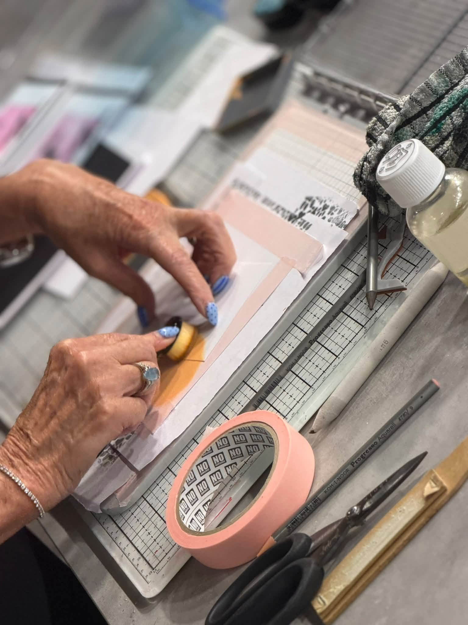 Karen blending yellow ink onto a masked piece of card