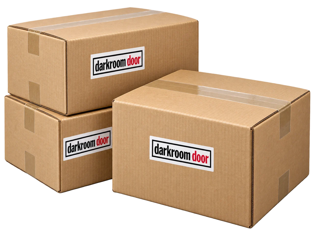 Illustration of three large Darkroom Door branded wholesale packing boxes